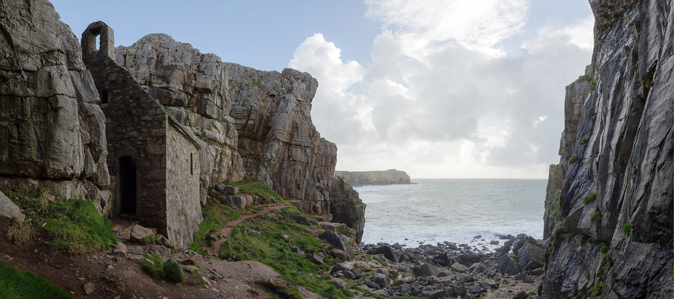 The little chapel of St Govan overlooks impressive cliffs along the Pembroke Coast, Wales